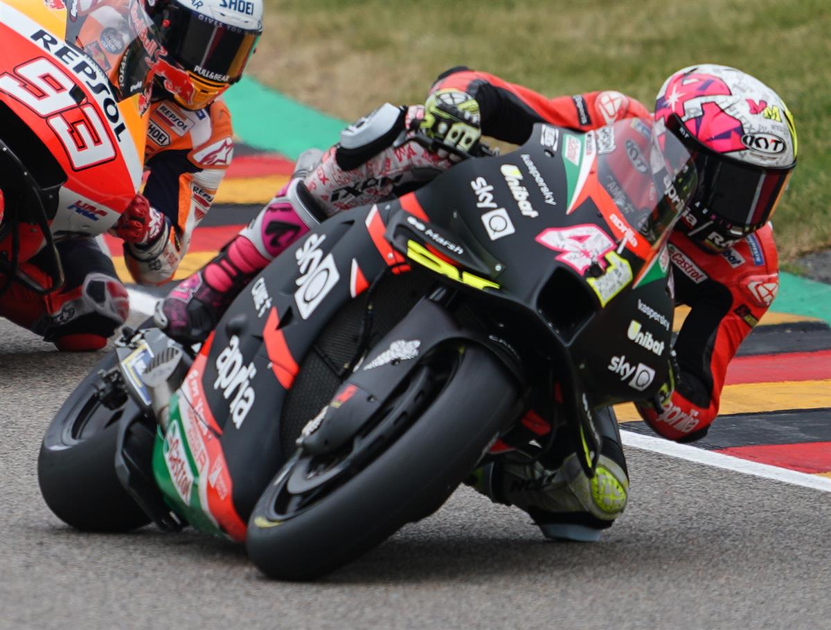 MotoGP racing pack bunching together into corner entry