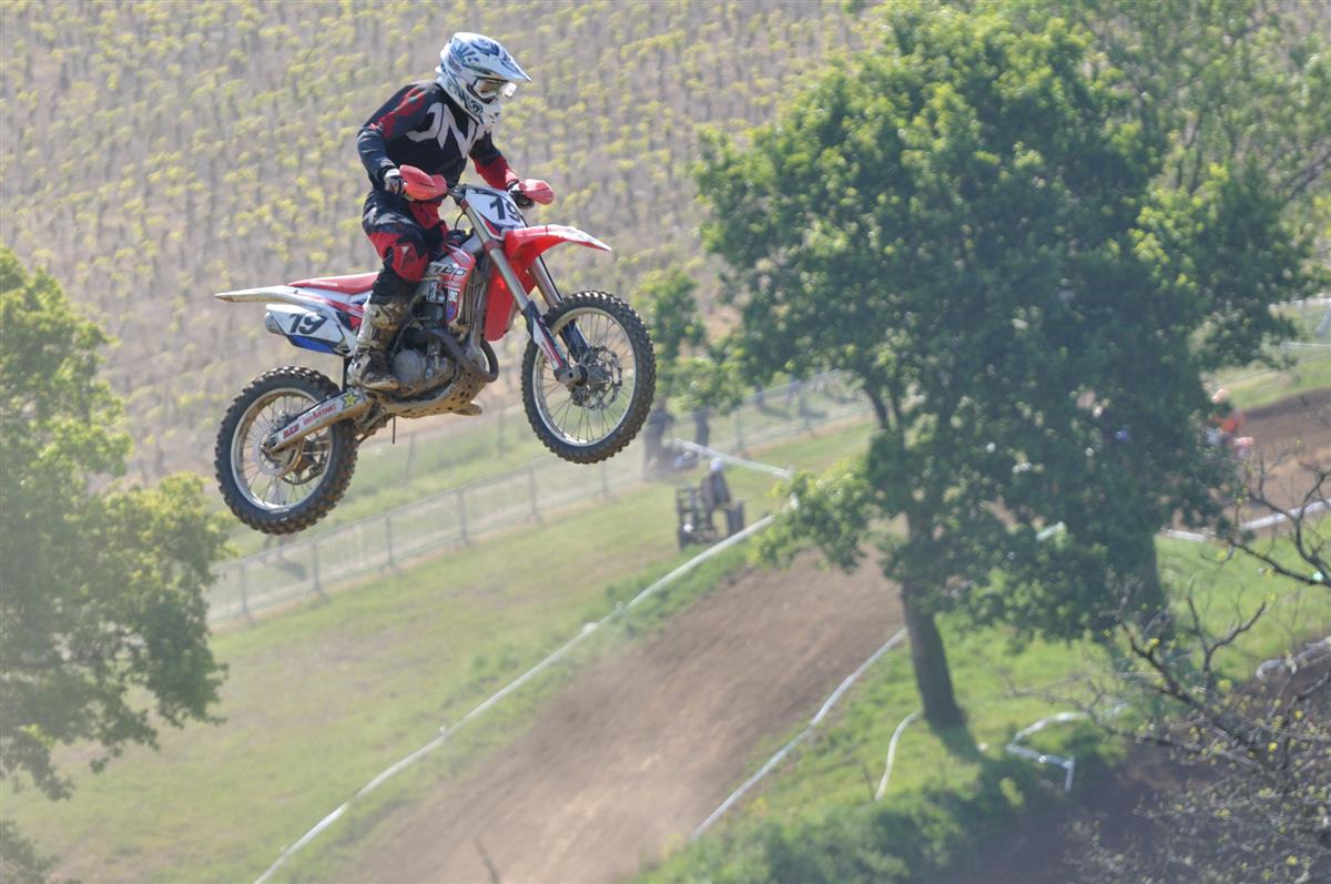 Hunter Lawrence and Jett Lawrence flying in close formation over championship stadium triple